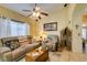 Comfortable living room with a ceiling fan, ample natural light, and neutral decor at 489 Beaconwood St, Henderson, NV 89052