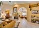 Open-concept living room with tile flooring, fireplace, and seamless flow to the dining area at 489 Beaconwood St, Henderson, NV 89052