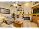 Inviting living room with a ceiling fan, stone fireplace, and comfortable seating at 489 Beaconwood St, Henderson, NV 89052