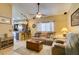 Comfortable living room with a ceiling fan, tile floors, and open access to the kitchen at 489 Beaconwood St, Henderson, NV 89052
