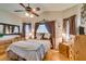 Bedroom featuring hardwood flooring, a ceiling fan, and a bright window at 489 Beaconwood St, Henderson, NV 89052