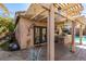 Backyard patio with outdoor kitchen under a pergola, complete with ceiling fans for comfortable outdoor dining and entertaining at 489 Beaconwood St, Henderson, NV 89052
