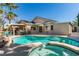 Backyard pool and spa with a patio and lush landscaping, perfect for entertaining and relaxing outdoors at 489 Beaconwood St, Henderson, NV 89052