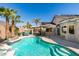 Sparkling backyard pool with lush landscaping, tiki hut and comfortable seating, ideal for enjoying warm days at 489 Beaconwood St, Henderson, NV 89052