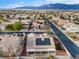 Neighborhood aerial showcasing many homes with solar panels, tile roofs, and desert landscaping at 5601 Quail Meadow Ct, Las Vegas, NV 89131