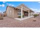 The backyard with patio cover, desert landscaping, and red rock ground cover at 5601 Quail Meadow Ct, Las Vegas, NV 89131