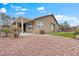 The backyard with patio cover, desert landscaping, and red rock ground cover at 5601 Quail Meadow Ct, Las Vegas, NV 89131