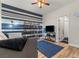 Comfortable bedroom with striped accent wall, television and an ensuite bathroom at 5601 Quail Meadow Ct, Las Vegas, NV 89131