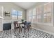 Bright breakfast nook with large windows, banquette seating, and a black-and-white geometric patterned floor at 5601 Quail Meadow Ct, Las Vegas, NV 89131