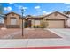 Inviting front exterior with beautiful landscaping, rock garden, and two-car garage, complete with desert landscaping at 5601 Quail Meadow Ct, Las Vegas, NV 89131