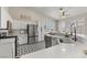 Bright kitchen with white cabinetry, stainless steel appliances, and unique black-and-white patterned flooring at 5601 Quail Meadow Ct, Las Vegas, NV 89131