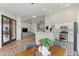 Open-concept design with a kitchen, dining area, and living room with stainless steel appliances at 5601 Quail Meadow Ct, Las Vegas, NV 89131