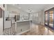 Open kitchen featuring an island, white cabinets, stainless appliances, and a breakfast nook with many windows at 5601 Quail Meadow Ct, Las Vegas, NV 89131
