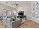 Cozy living room featuring a vaulted ceiling, a large window, and a gray sectional sofa at 5601 Quail Meadow Ct, Las Vegas, NV 89131