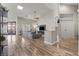 Open-concept living room with hardwood floors, a large window, and modern furnishings at 5601 Quail Meadow Ct, Las Vegas, NV 89131