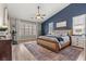 Charming main bedroom with hardwood floors, a dark blue accent wall, and large windows at 5601 Quail Meadow Ct, Las Vegas, NV 89131
