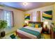 Comfortable bedroom with colorful decor, stylish mid century furniture and ample light at 648 Utah St, Boulder City, NV 89005