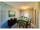 Staged dining room with green chairs, a modern table and decorative wallpaper at 648 Utah St, Boulder City, NV 89005