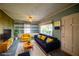 Staged living room with cozy seating, built in bookcases and ample natural light at 648 Utah St, Boulder City, NV 89005