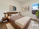 Cozy bedroom featuring a queen sized bed, contemporary decor, and neutral colors, virtually staged at 7255 W Sunset Rd # 1116, Las Vegas, NV 89113