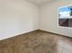 An empty bedroom featuring tiled floors and a window providing ample light at 7255 W Sunset Rd # 1116, Las Vegas, NV 89113