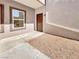 Condo entrance with window, brown door, gravel, concrete, and neutral exterior at 7255 W Sunset Rd # 1116, Las Vegas, NV 89113