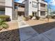 Exterior of a light beige two-story condominium with a staircase and desert landscaping at 7255 W Sunset Rd # 1116, Las Vegas, NV 89113