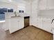 Modern kitchen features stainless steel dishwasher and white cabinets with granite countertops at 7255 W Sunset Rd # 1116, Las Vegas, NV 89113
