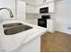 A modern kitchen featuring white countertops, cabinetry and black appliances at 7255 W Sunset Rd # 1116, Las Vegas, NV 89113