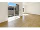 Bright living room with tile flooring, white walls, and sliding glass door to outdoor patio space at 7255 W Sunset Rd # 1116, Las Vegas, NV 89113