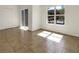 An empty living room featuring tiled floors and a window providing ample light at 7255 W Sunset Rd # 1116, Las Vegas, NV 89113