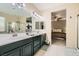 Bathroom features a double sink vanity, a large mirror, and glass shower enclosure at 7413 Old Compton St, Las Vegas, NV 89166