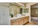 Bathroom featuring double sinks, a large mirror, and ample vanity storage at 7820 Wedlock Ln, Las Vegas, NV 89129