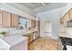 Efficient kitchen featuring tile countertops, backsplash, flooring, and wood cabinets at 7820 Wedlock Ln, Las Vegas, NV 89129