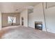 Open-concept living area with carpet, natural light, and a fireplace with tiled accents at 7820 Wedlock Ln, Las Vegas, NV 89129