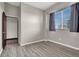 Bright bedroom featuring wood-look floors, large window and neutral wall color ready for your personal touches at 822 Fairview Dr, Henderson, NV 89015