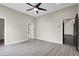 Spacious bedroom featuring a ceiling fan, light gray walls, and wood-look floors for a modern look at 822 Fairview Dr, Henderson, NV 89015