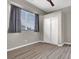 Cozy bedroom with wood-look floors, a double-door closet, and a sunny window for natural light at 822 Fairview Dr, Henderson, NV 89015