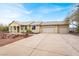Charming single-story home with a three-car garage, tile roof, and desert landscaping at 822 Fairview Dr, Henderson, NV 89015