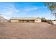 Rear exterior view showing the house and covered patio, showcasing the vastness of the property's backyard at 822 Fairview Dr, Henderson, NV 89015