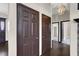 Hallway with hardwood floors, decorative lighting and multiple doors at 822 Fairview Dr, Henderson, NV 89015