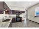 Kitchen featuring brown cabinets, stainless steel appliances, gray countertops, and lots of natural light at 822 Fairview Dr, Henderson, NV 89015