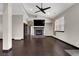 Bright living room with high ceilings, dark floors, and a modern fireplace with mounted television at 822 Fairview Dr, Henderson, NV 89015