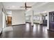 Open-concept living room featuring hardwood floors, natural light, and modern light fixture at 822 Fairview Dr, Henderson, NV 89015