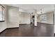 Open-concept living space with a fireplace, dark floors, and a ceiling fan at 822 Fairview Dr, Henderson, NV 89015
