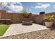 Inviting backyard with brick fire pit, seating, and desert landscaping, perfect for outdoor relaxation and entertaining at 8501 Bellery Ave, Las Vegas, NV 89143