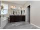 Spacious bathroom featuring double sinks, large mirror, and a separate tub at 8501 Bellery Ave, Las Vegas, NV 89143