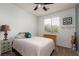 Comfortable bedroom showcasing a stylish lamp, a window with natural light, and baseball decorations at 8501 Bellery Ave, Las Vegas, NV 89143