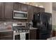 Updated kitchen features stainless steel appliances, granite counters, and dark wood cabinets at 8501 Bellery Ave, Las Vegas, NV 89143