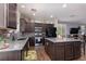 Stylish kitchen featuring dark wood cabinets, granite countertops, and a mosaic backsplash at 8501 Bellery Ave, Las Vegas, NV 89143